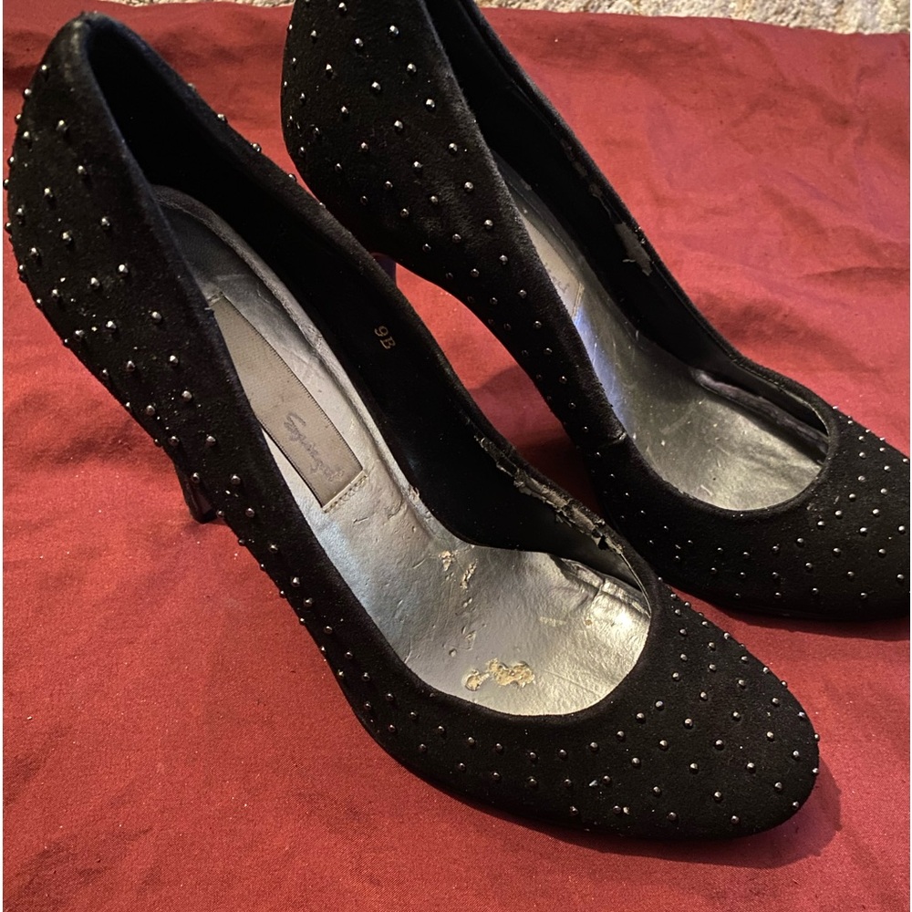 Silver stud on black suede